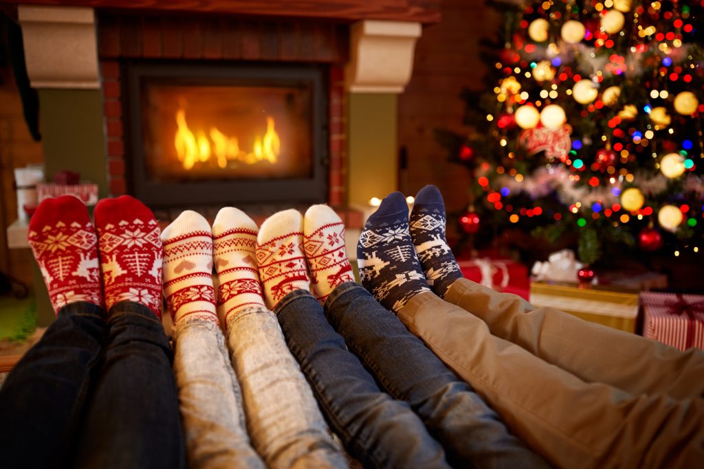 Family with their feet up in front of the fire