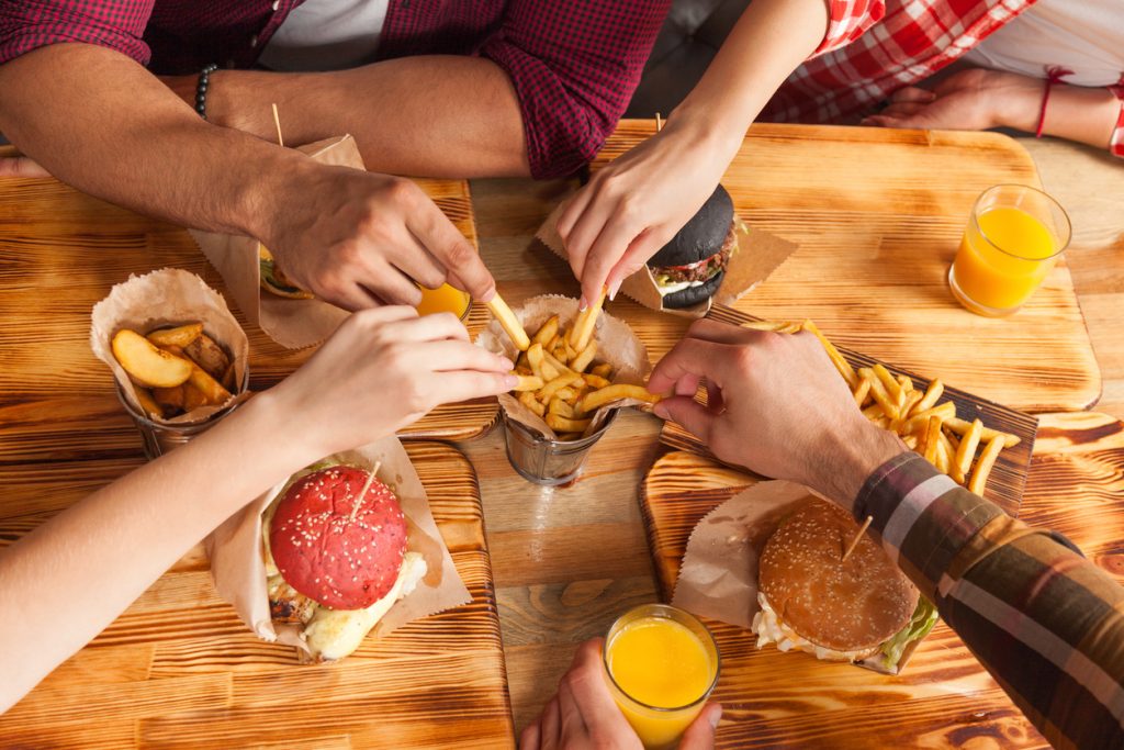 Students eating together celebrating their results