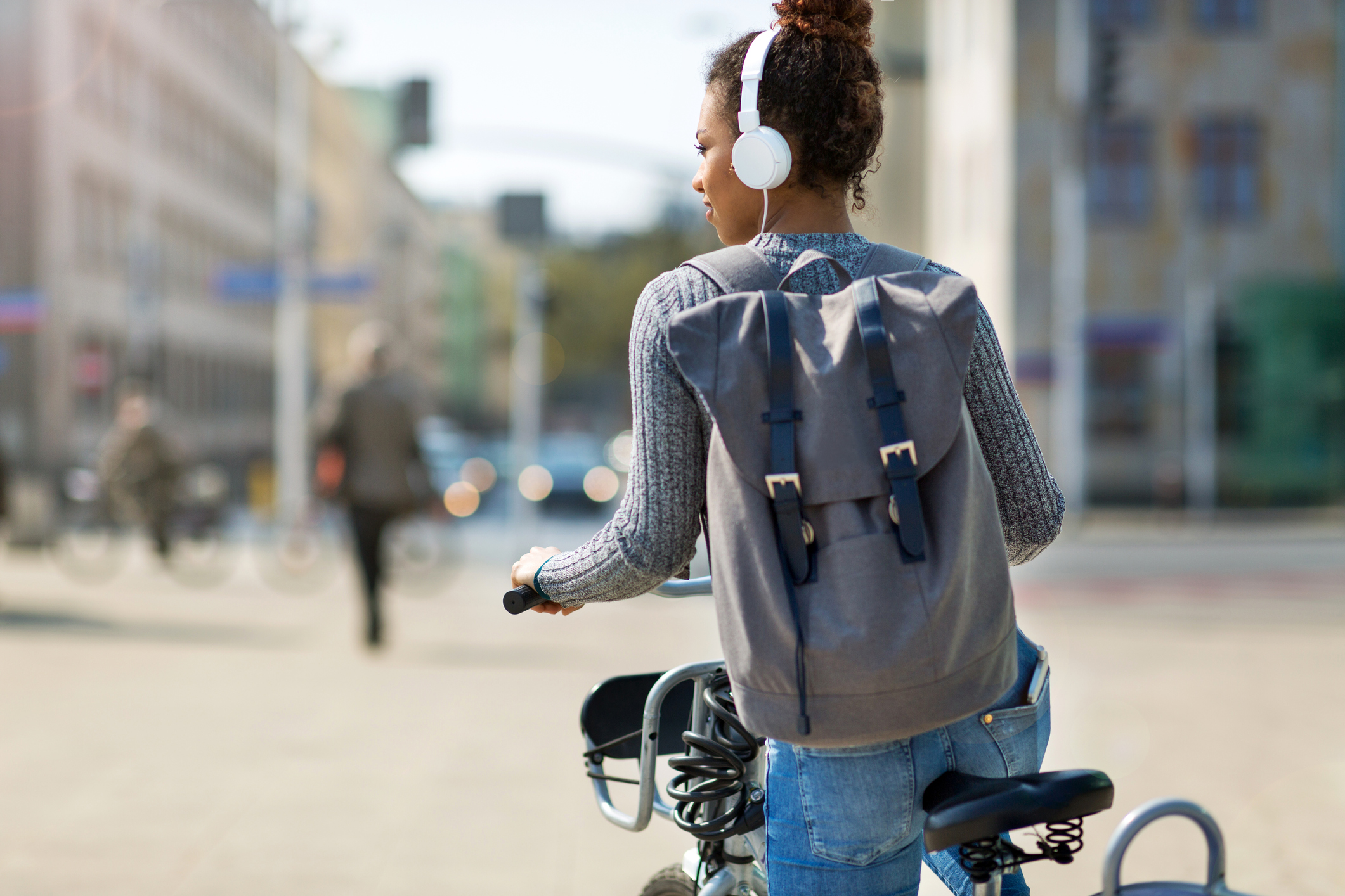 Woman riding bicycle on city street