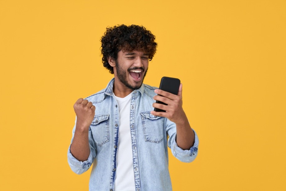 man happy with a level results on his phone