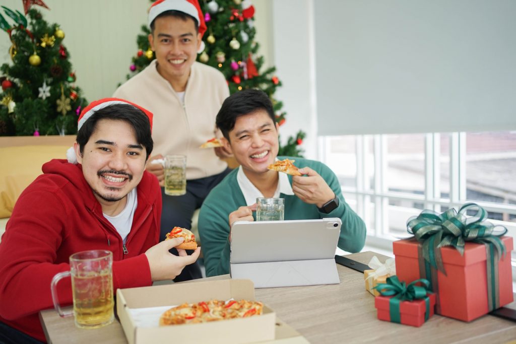 Students eating pizza in their student accommodation at Christmas time