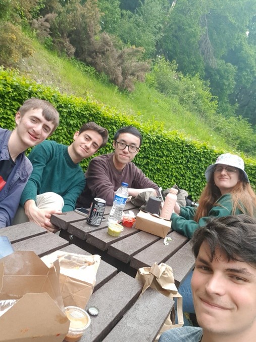 Students sat around a picnic bench