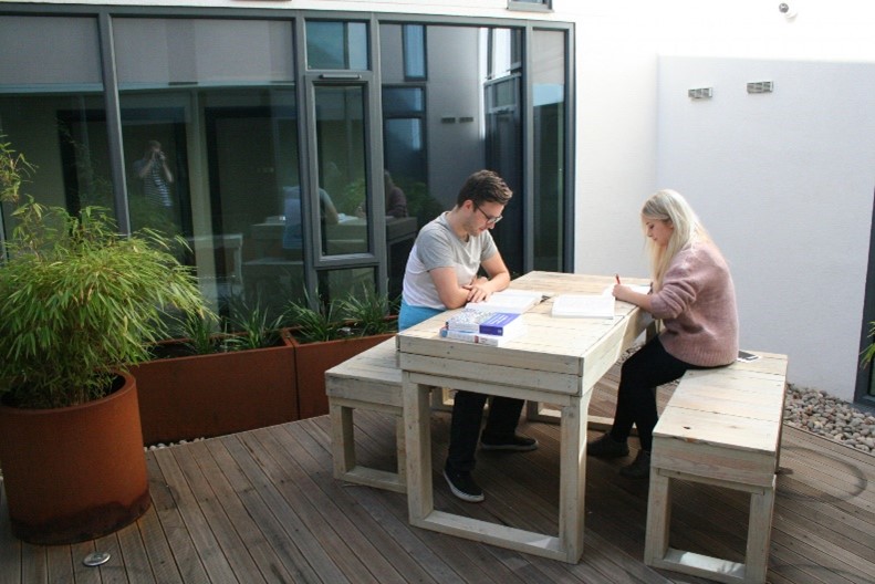 Students sat outside on a bench