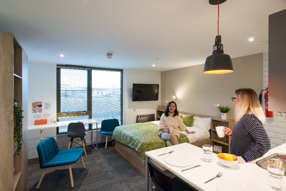 two female students smiling together in student accommodation