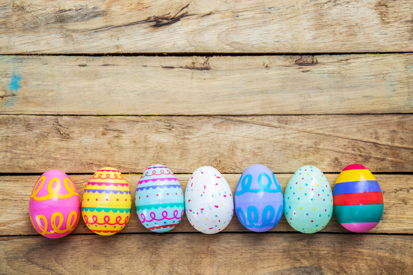 Easter eggs on wooden background with space