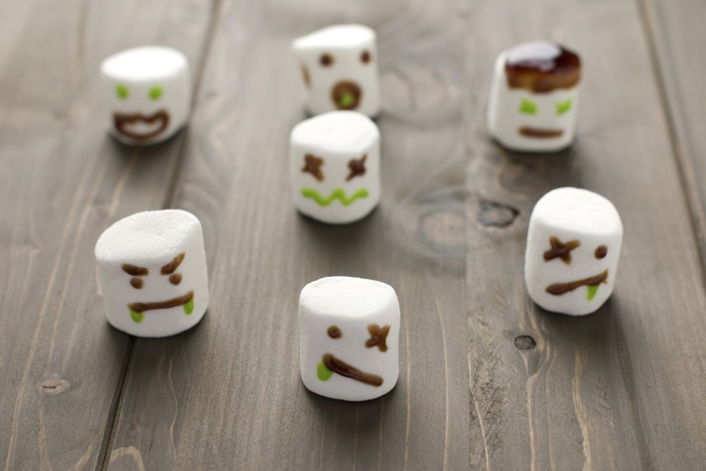 Halloween marshmallow zombies on a wooden background