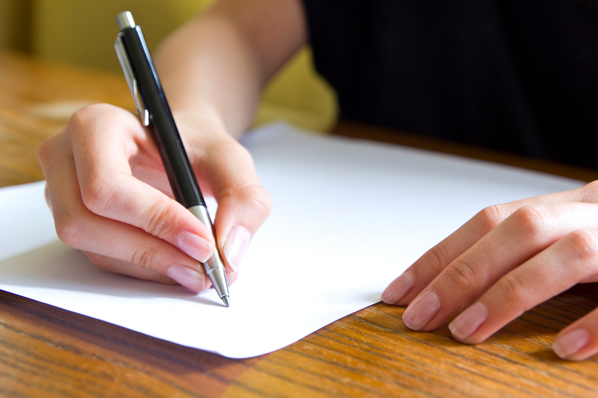 Close up of a female student writing with a pen